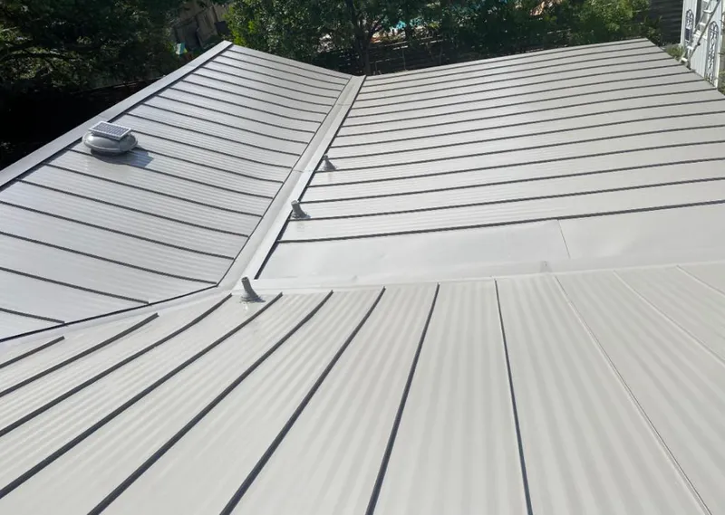 Solar attic fan installed on a metal roof for Roof Ventilation in Primera